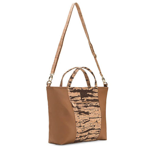 Handmade from renewable, eco-friendly cork in Massachusetts.   Cork fabric Eco-friendly + PVC-free faux leather Organic cotton lining One outside zipper pocket Two inside slip pockets Removable and adjustable strap Zipper closure 11”H x 15.5”W x 4”D