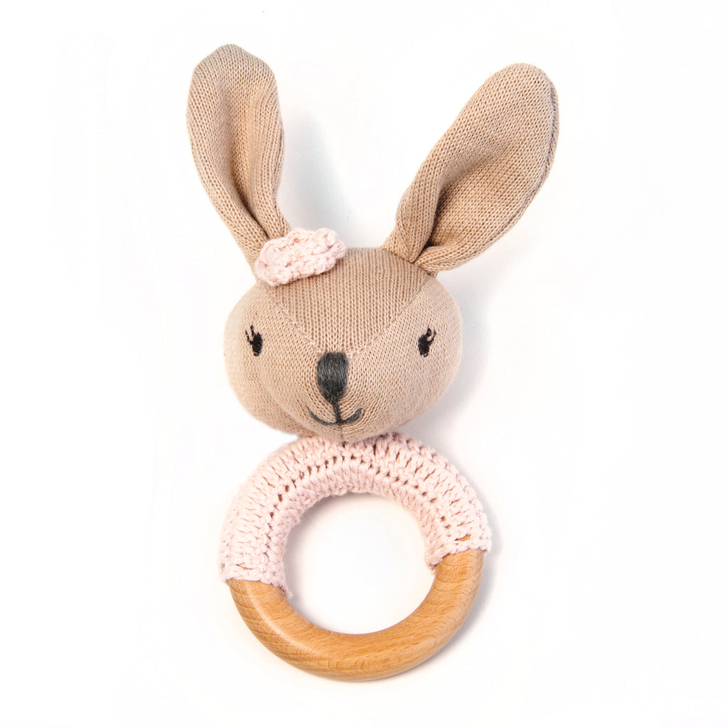 A pretty in pink wooden baby rattle featuring a sweet bunny!